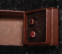 A pair of 9ct gold oval drop earrings inset with stud garnet stones. Measures:1.5g.