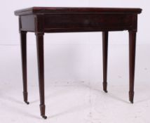 An Edwardian mahogany card / games table having hinged top with tapered legs and original castors.