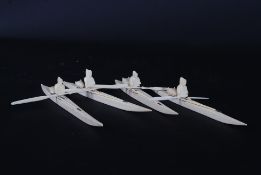 A set of early 20th century Inuit carved marine sea ivory carvings - figurines of Kayaks and