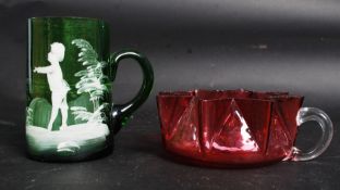 A Mary Gregory Green Glass Beaker depict