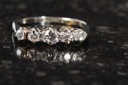 An 18ct gold five stone half eternity ri