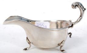 A silver hallmarked creamer, bearing rub