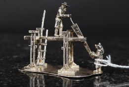 A hallmarked silver diorama of woodworke