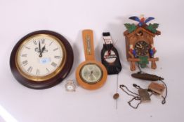A collection of clocks to include a Swiss style Cuckoo clock, novelty Guinness clock and others.