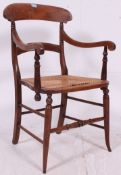An Edwardian mahogany bergere / caned armchair.