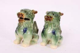 A pair of 20th century Chinese oriental dragon / temple dogs in green colouring.