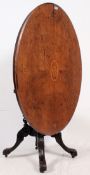 A Victorian burr walnut and marquetry inlaid tilt top loo table having quadruped base with oval