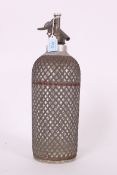 A vintage retro / glass and mesh soda syphon  having original red line finish with the glass base