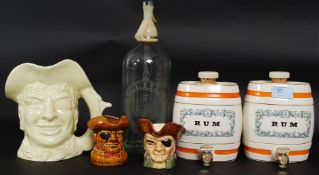 A mixed lot of china to include 2x Wade Whiskey barrels, Schweppes syphon and 3x character jugs.