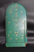 A vintage Bagatelle wooden game in the original green finish complete balls etc