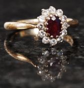 A 9ct gold ladies diamond and ruby stone flower head ring.