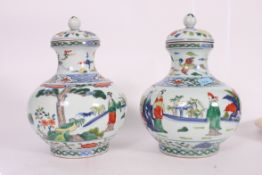 A large pair of Chinese famille verte vases bearing marks to the base. Complete with the lids.