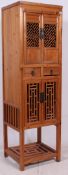A Chinese 20th century upright yellow pine pedestal cabinet - marriage cupboard.