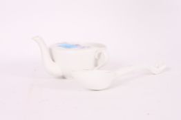 A Meissen continental ceramic spoon bearing blue crossed swords markings to the base together with