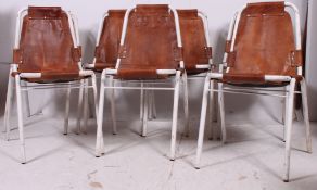 A set of 7 stacking leather and painted tubular metal chairs in the manner of Charlotte Perriand -