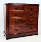A good Victorian flame mahogany 2 over 3 chest of drawers raised on bun feet with 2 short over 3