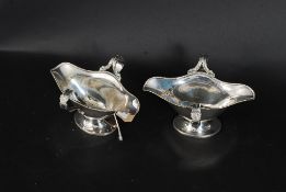 A pair of good quality Beresford silver plate twin sided creamers of lozenge form with hoop handles