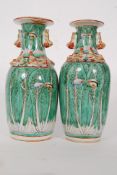 A pair of early 20th century Chinese oriental green leaf vases. No makers marks, hand painted.
