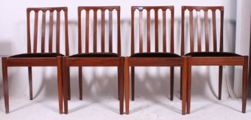 A set of 4 1970's teak wood retro dining chairs by Meredew having tapered supports with the
