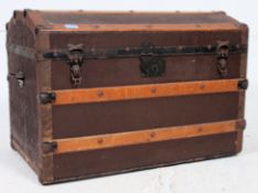 A Victorian brown canvas and wooden bound dome top steamer trunk chest with hinged top having clasp