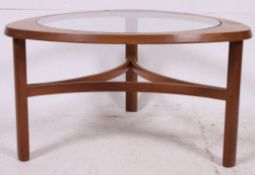 A 1970's teak and glass atomic style retro coffee table having circular inset glass top to the
