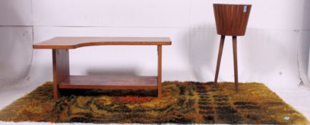 A 1960's retro teak Danish style planter / plant stand raised on angled legs together with a shaped