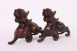 A pair of bronze early 20th century Chinese oriental temple dogs