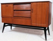 A retro beautility 1950's teak wood sideboard raised on suspension set ebonised base having a wide