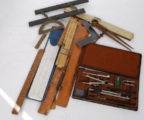 A collection of draughtsmans tools to include various sized set squares,