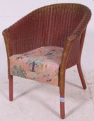 A good 20th century vintage Lloyd Loom childs chair with original fabric overstuffed seat.