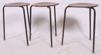 A vintage 1950's set of 3 stacking stools raised on tubular metal legs with circular ply wood