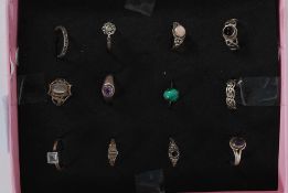 A collection of 12x silver and white metal ladies rings. Weight: 29g GW.
