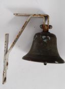 A vintage wall hanging brass school / works bell on original bracket