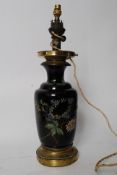 A 20th century black ceramic and brass oil lamp converted to an electric table / hall light.