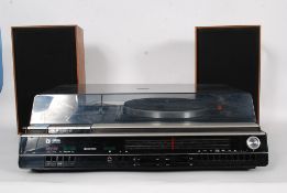 A retro Ultra stereo music system, containing a Garrard record deck, tape player and radio.