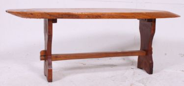 A retro 1950's vintage driftwood trunk coffee table raised on shaped supports being well polished.