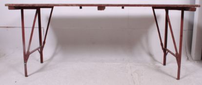 A mid 20th cenutry Air Ministry stamped trestle table having folding metal legs with planked top