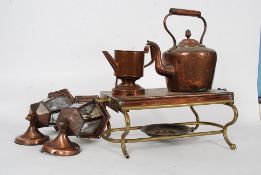 A copper and brass arts and crafts food warming stand together with a Victorian copper kettle and