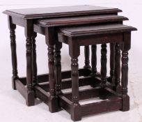 An oak nest of three tables, rectangular top, turned and blocked supports.