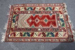 A good 20th century handwoven Persian prayer rug having red ground with central Mihrab