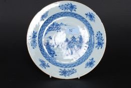 An 18th century Chinese blue and white plate with a willow pattern design to the centre having