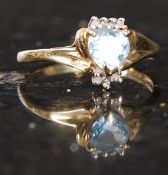 A 10ct gold yellow metal and aqua marine dress ring. 2g.