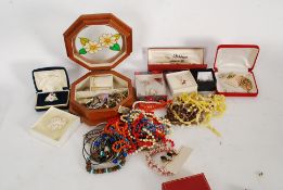 A collection of costume jewellery to include brooches, pendants,