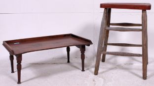 A Victorian elm milking stool on turned legs along with an Edwardian butlers bed tray having