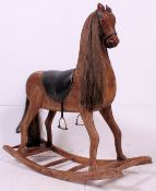 A 20th century large hardwood rocking horse.