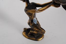 A 20th century faux bronze figurine of an Art Deco lady being raised on lozenge base marked  GP 084.