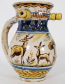 A continental 19th century Faience puzzle jug being handpainted with scenes of bull