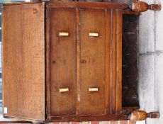 A 1930's - 1940's oak bureau having a fully appointed interior being raised on turned legs