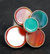 A silver and agate set Danish modernist ring in the manner of Ellis Kauppi. The 5 headed ring