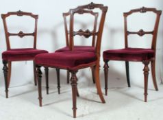 Four Victorian mahogany dining chairs on reeded turned and tapered legs.
